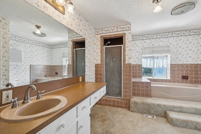 bathroom featuring vanity, a textured ceiling, and shower with separate bathtub