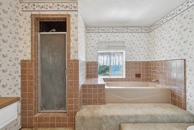 bathroom with vanity, a textured ceiling, and independent shower and bath