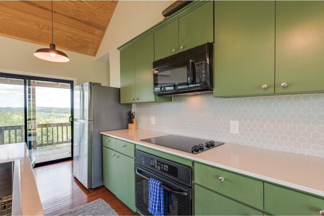 kitchen featuring vaulted ceiling, black appliances, backsplash, and green cabinetry