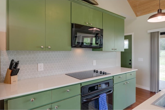 kitchen with dark wood-type flooring, tasteful backsplash, vaulted ceiling, green cabinetry, and black appliances