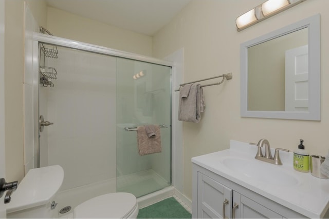 bathroom with an enclosed shower, toilet, and vanity