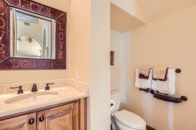 bathroom with toilet and vanity