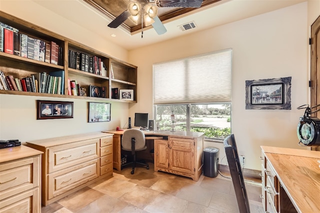 office space with ceiling fan, light tile patterned floors, and a tray ceiling