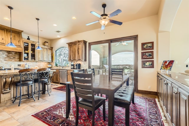 tiled dining space featuring ceiling fan