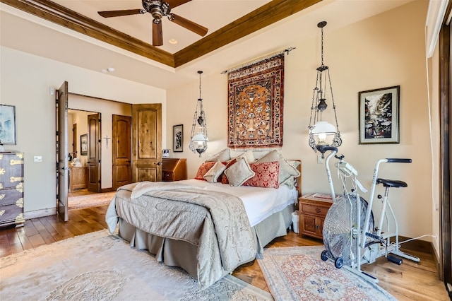 bedroom with light wood-type flooring, ceiling fan, and crown molding