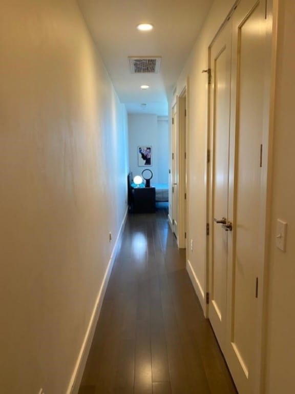 hallway with dark hardwood / wood-style floors