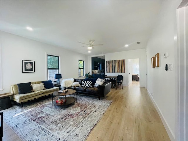 living room with ceiling fan and light hardwood / wood-style floors