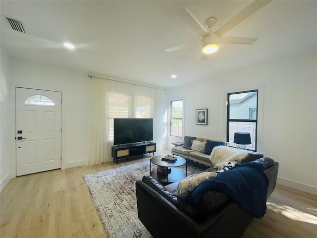 living room with ceiling fan and light wood-type flooring