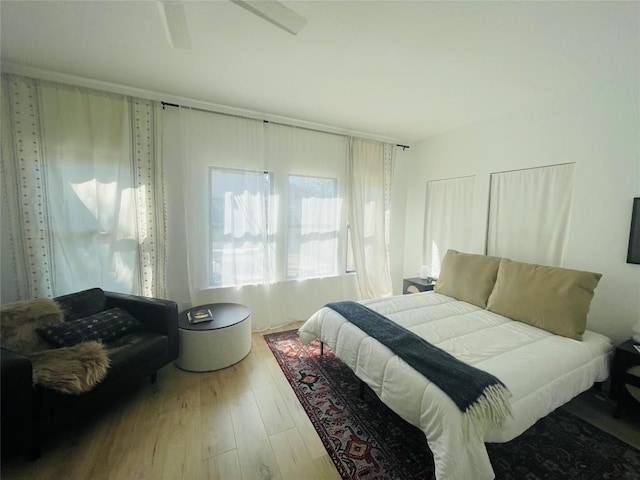 bedroom with hardwood / wood-style flooring and ceiling fan