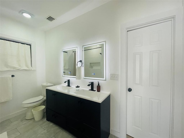 bathroom featuring vanity and toilet