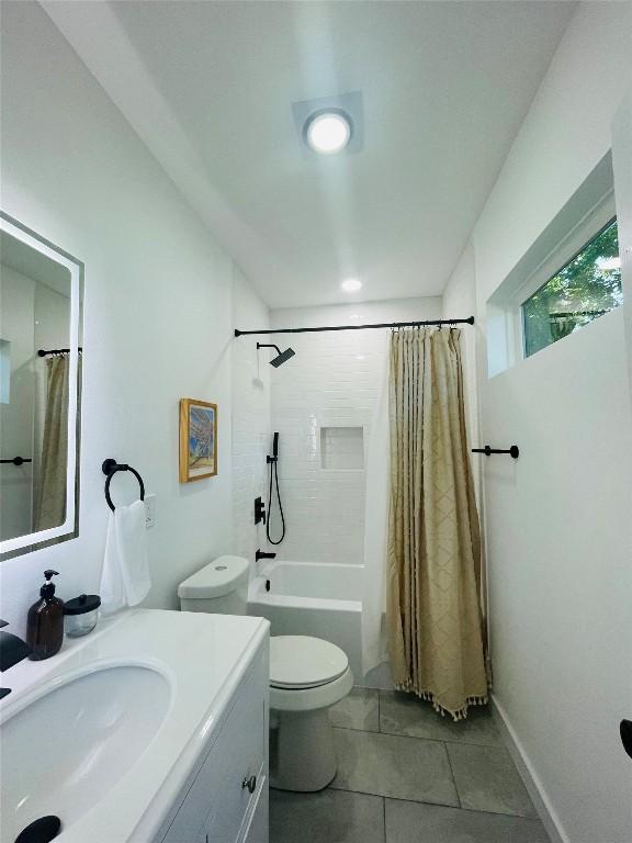 full bathroom with tile patterned flooring, vanity, shower / tub combo with curtain, and toilet