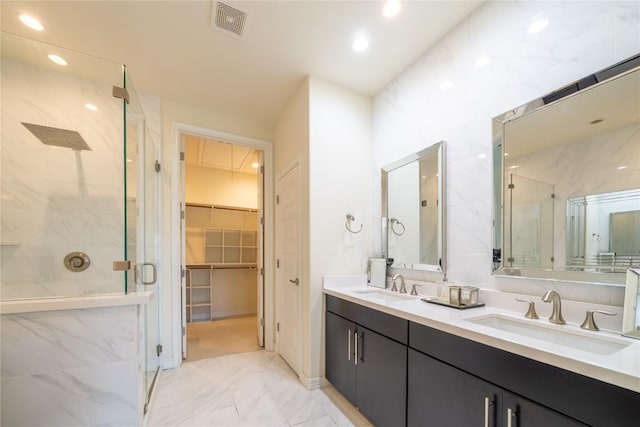 bathroom with vanity and a shower with door