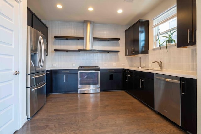 kitchen with sink, wall chimney exhaust hood, dark hardwood / wood-style floors, appliances with stainless steel finishes, and tasteful backsplash