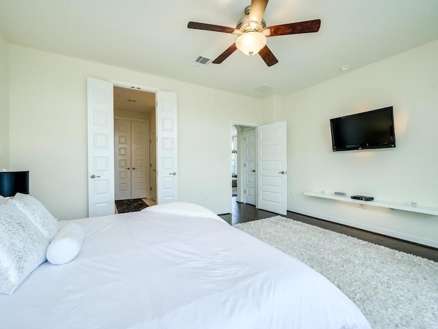 bedroom with ceiling fan and dark hardwood / wood-style flooring