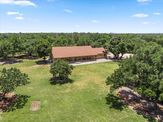 bird's eye view with a wooded view