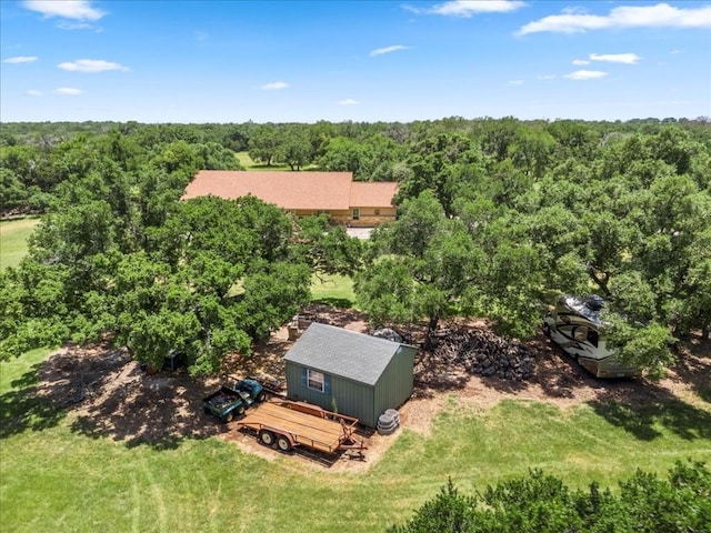 bird's eye view with a wooded view