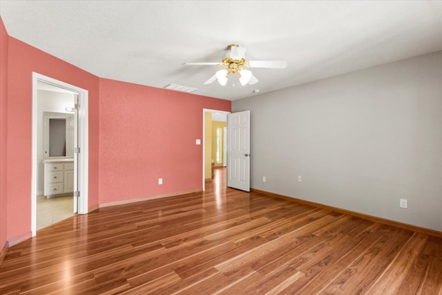 empty room featuring hardwood / wood-style flooring and ceiling fan