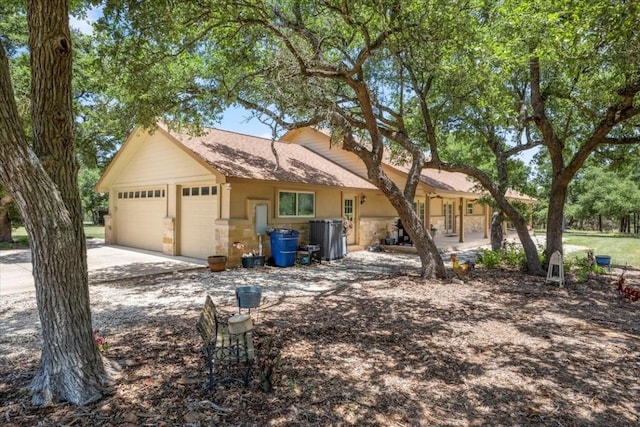 ranch-style home featuring an attached garage and driveway