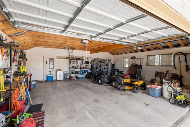 garage with electric panel and a garage door opener