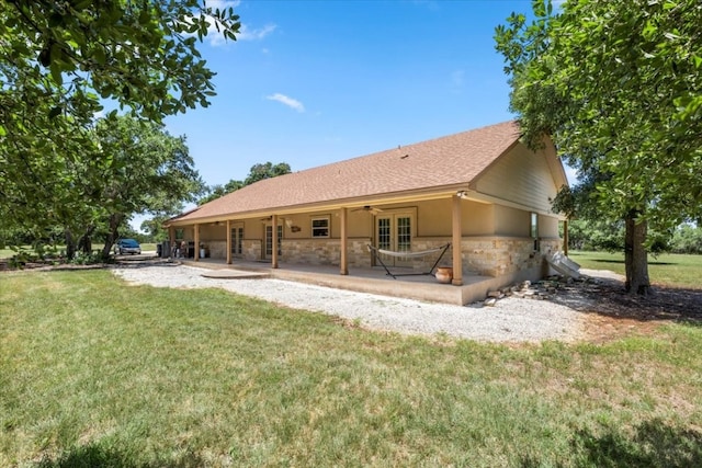 back of property featuring a patio and a lawn