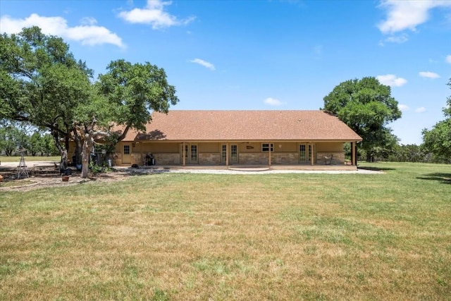 back of house featuring a patio area, a lawn, and french doors