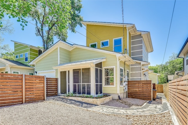 rear view of property with a sunroom