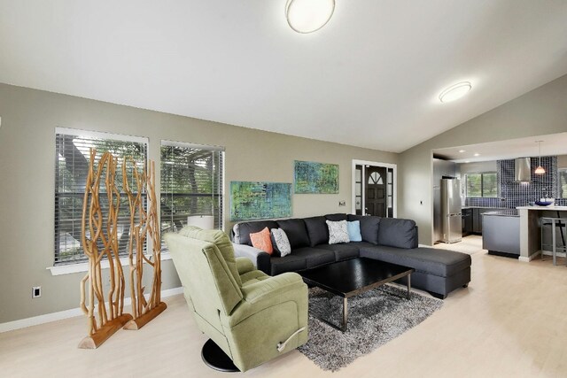 living room featuring light hardwood / wood-style flooring and lofted ceiling