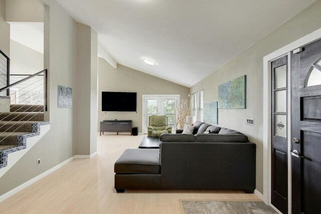 living room featuring lofted ceiling and light wood-type flooring