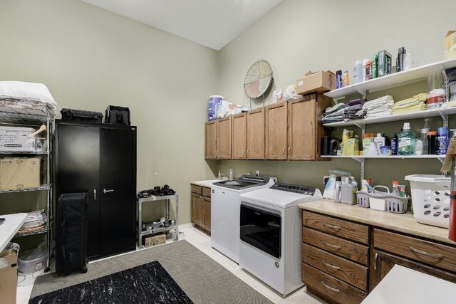 laundry area featuring cabinets and washing machine and dryer