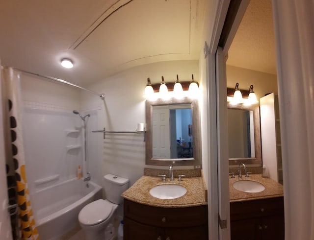 full bathroom with vanity, shower / bath combo, and toilet