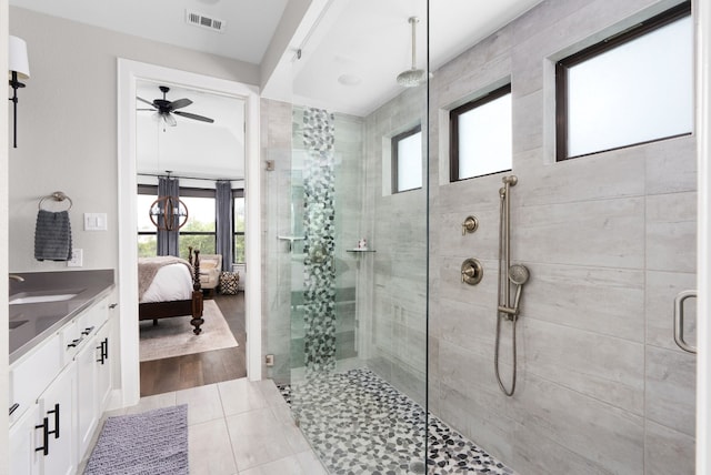 bathroom featuring tile patterned flooring, vanity, ceiling fan, and a shower with shower door