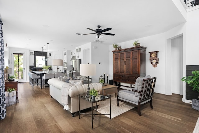 living room with hardwood / wood-style flooring and ceiling fan