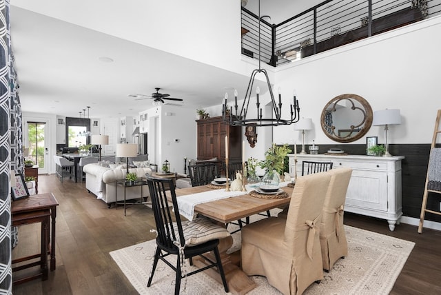 dining area featuring dark hardwood / wood-style floors and ceiling fan with notable chandelier