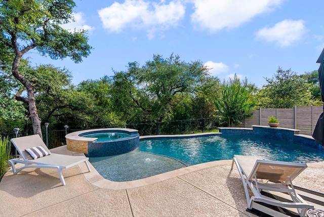 view of swimming pool with an in ground hot tub