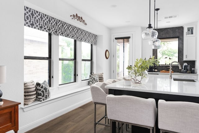 dining space with dark wood-type flooring and sink