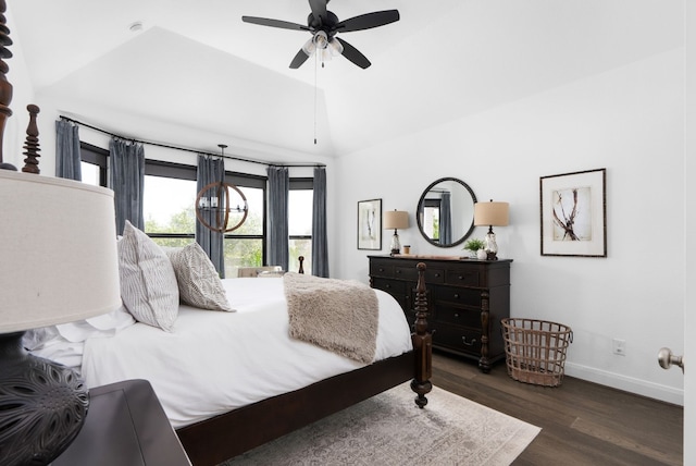 bedroom featuring dark hardwood / wood-style floors, vaulted ceiling, and ceiling fan