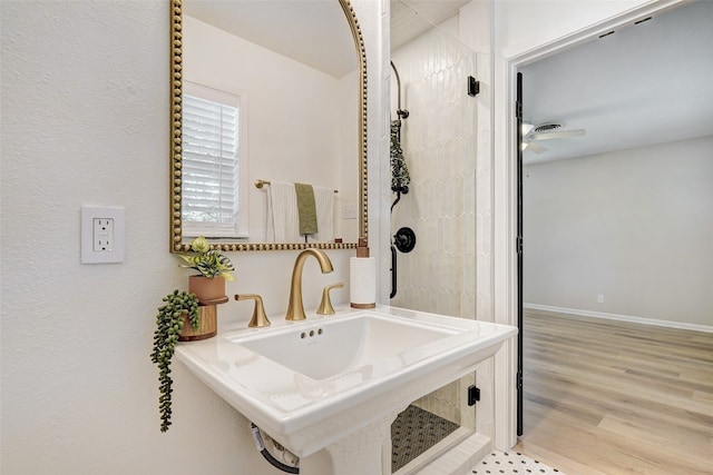 bathroom featuring ceiling fan and hardwood / wood-style flooring