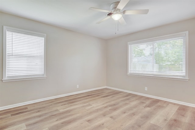 unfurnished room with light wood-type flooring and ceiling fan