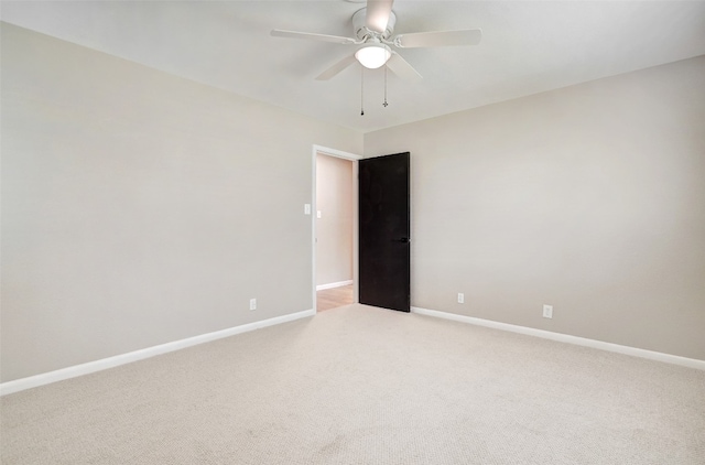 spare room featuring carpet flooring and ceiling fan