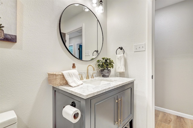 bathroom featuring hardwood / wood-style floors, vanity, and toilet