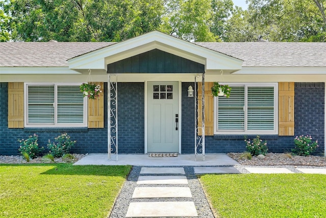 doorway to property featuring a yard