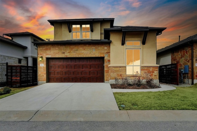 view of front of property with a garage and a lawn