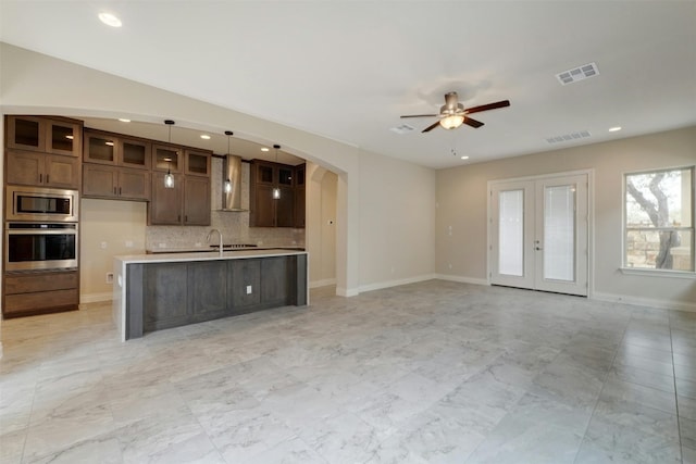 interior space with light tile patterned flooring, sink, french doors, and ceiling fan