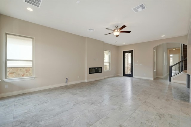 unfurnished living room with ceiling fan and light tile patterned floors