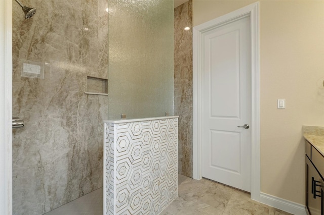 bathroom with vanity, tile patterned floors, and a tile shower