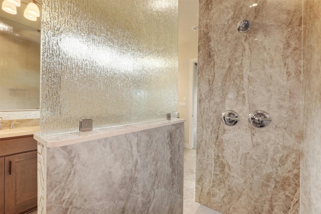 bathroom featuring walk in shower, tile patterned flooring, and vanity