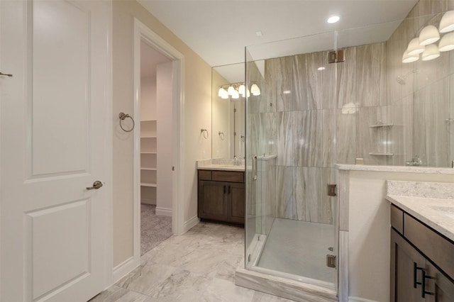 bathroom with vanity, tile patterned floors, and a shower with door