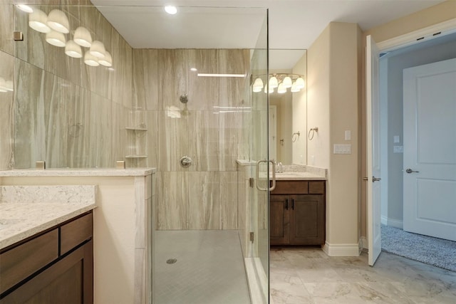 bathroom featuring tile patterned flooring, a shower with shower door, and vanity