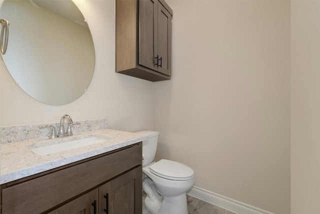 bathroom with vanity, toilet, and tile patterned floors