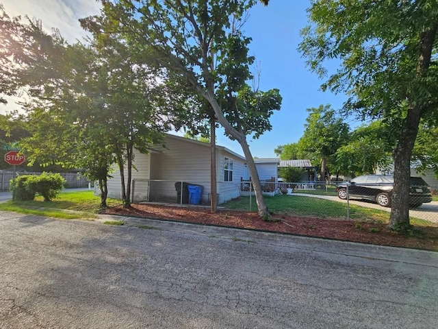 view of home's exterior featuring fence private yard and driveway